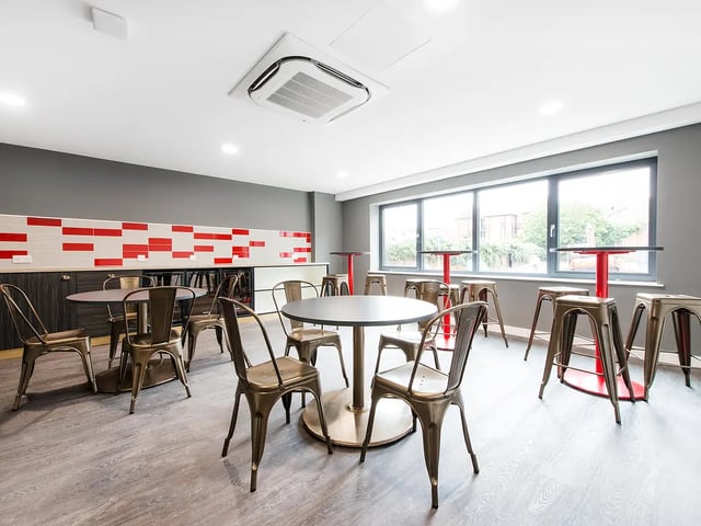 Modern common area with tables and chairs living room at Yugo Austen House in Southampton Student Accommodation