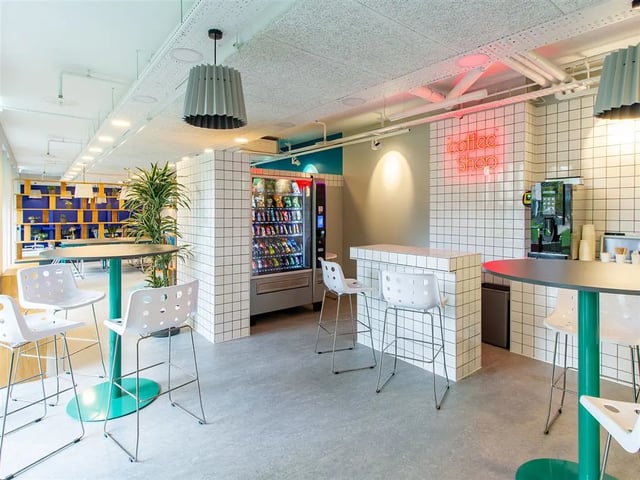 Coffee shop with vending machine bar and seating area at Benedict's Gate in Norwich Student Accommodation