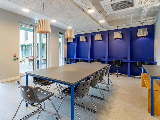 Long table with chairs study area at Benedict's Gate in Norwich Student Accommodation