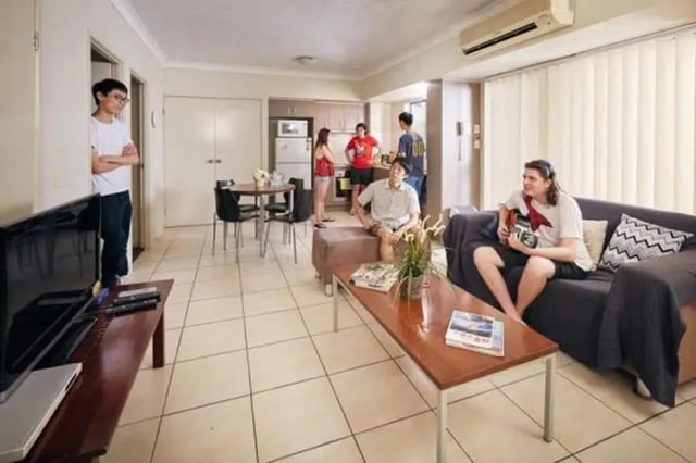 Sofa table television and dining area living room at Genesis 1 in Brisbane Student Accommodation
