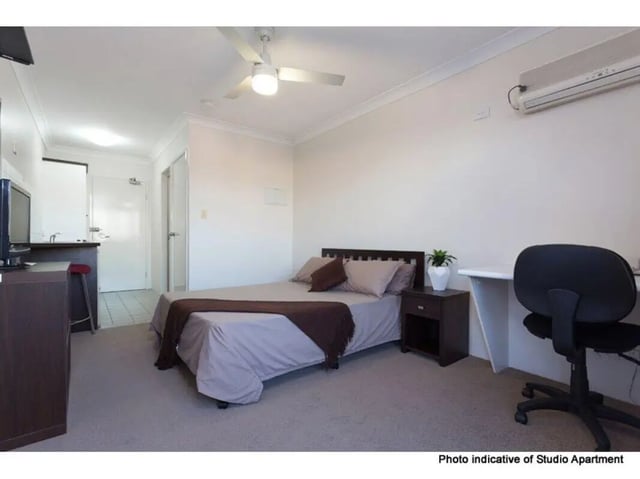 Bed desk chair and kitchen area studio apartment at Altitude Taringa in Brisbane Student Accommodation