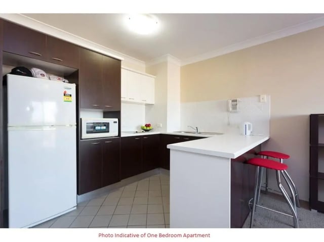 Fridge microwave cabinets counter with stools kitchen at Altitude Taringa in Brisbane Student Accommodation