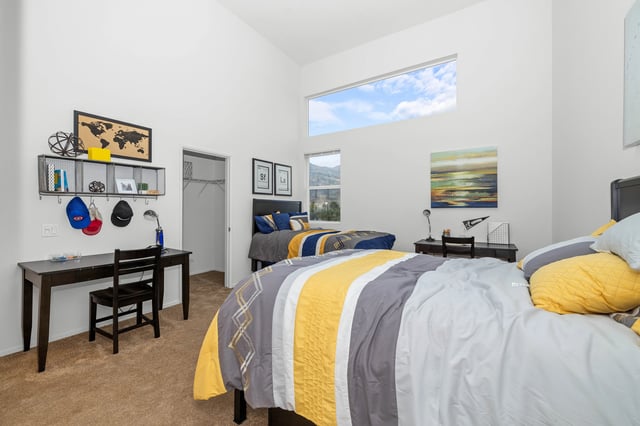 Two beds with desks and shelves bedroom at The Glen in San Bernardino Student Accommodation