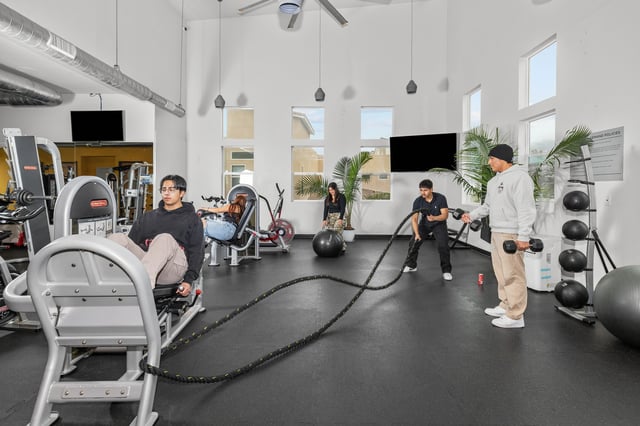 Fitness equipment and people working out gym at The Glen in San Bernardino Student Accommodation