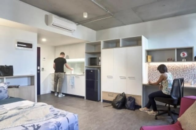 Bed kitchen study area people student accommodation at Student One Elizabeth Street in Brisbane Student Accommodation