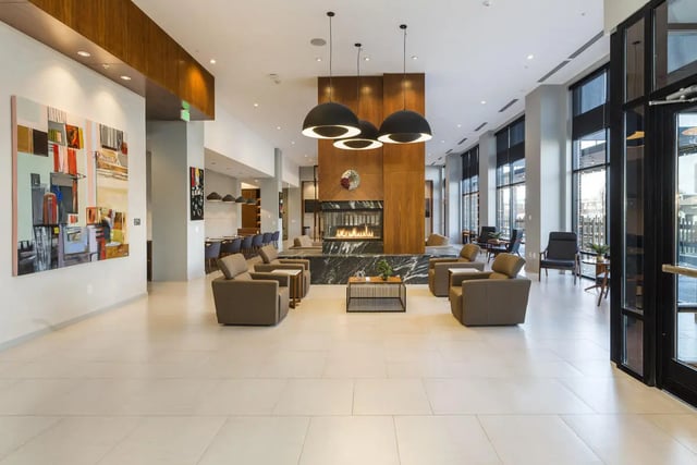 Modern lounge area with fireplace seating and art living room at 24 Fifty at University Park in Denver Student Accommodation