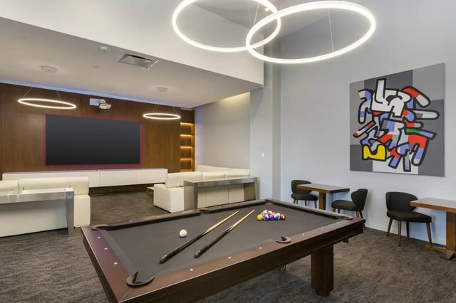 Pool table couches large screen television playing area at 24 Fifty at University Park in Denver Student Accommodation