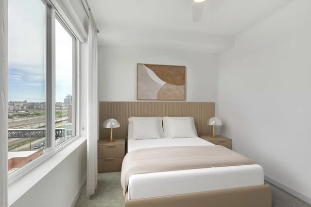 Bed with lamps nightstands art and window bedroom at Alloy Sunnyside in Denver Student Accommodation