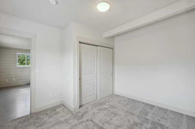 Closet doors and carpeted floor bedroom at Tiltn Hiltn Apartments in Eagle Student Accommodation