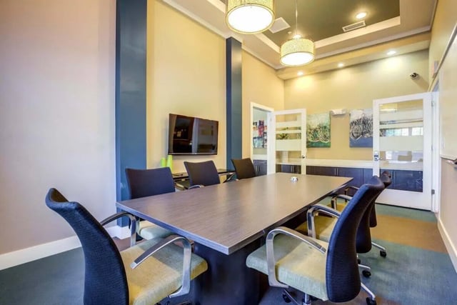 Table chairs TV and artwork meeting room at The Union Charlotte in Charlotte Student Accommodation