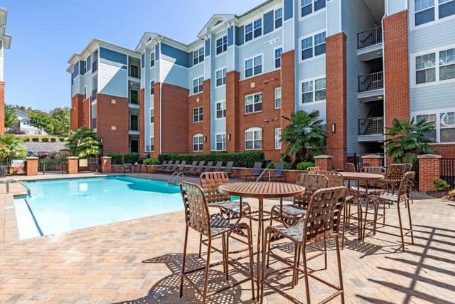 Poolside tables chairs and lounge chairs exterior at The Union Charlotte in Charlotte Student Accommodation
