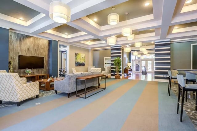 Comfortable seating with TV and tables living room at The Union Charlotte in Charlotte Student Accommodation