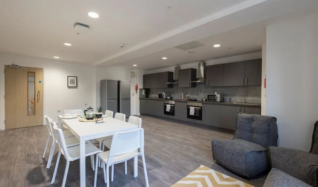 White dining table with chairs modern kitchen living area at The Cavendish in Winchester Student Accommodation