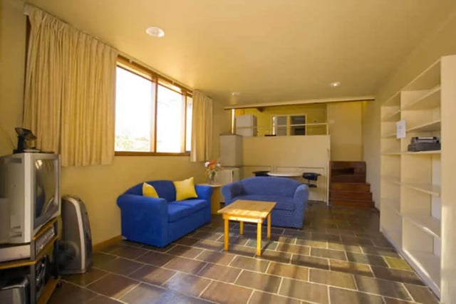 Two blue sofas small table and television living room at Greenwood House in Melbourne Student Accommodation