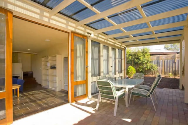 Table and chairs on patio with view inside exterior at Greenwood House in Melbourne Student Accommodation