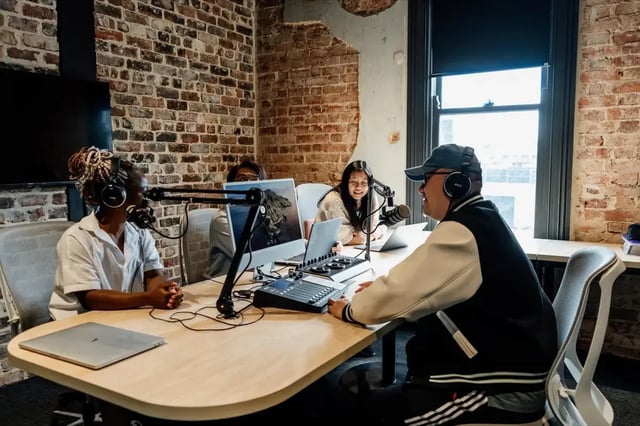 People podcasting at desk with computers and microphones lounge at Perth Central in Perth Student Accommodation