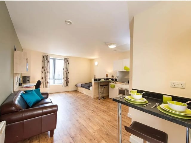 Sofa bed desk kitchen area with dining counter living room at Optima in Loughborough Student Accommodation