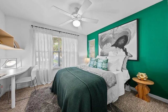 Bed desk ceiling fan art bedroom at Cabana Beach Gainesville in Gainesville Student Accommodation