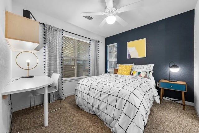 Bed desk lamp window patterned bedding and nightstand bedroom at Cabana Beach Gainesville in Gainesville Student Accommodation