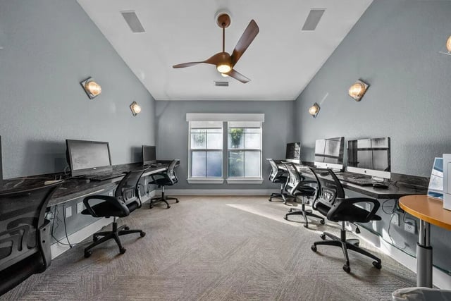Computers desks chairs ceiling fan study area at Cabana Beach Gainesville in Gainesville Student Accommodation
