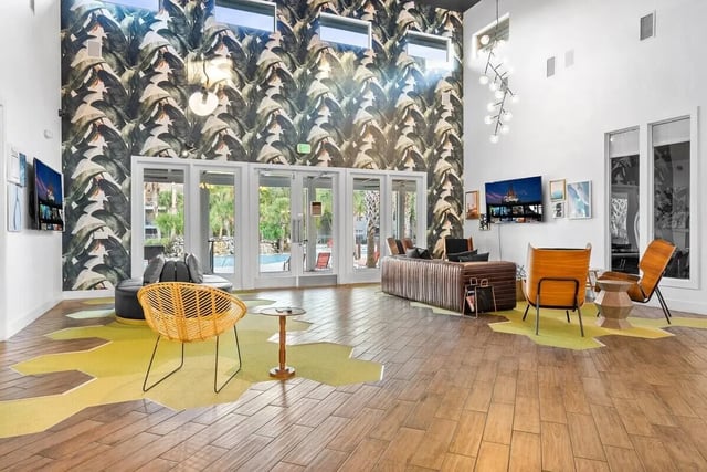 Lounge with wicker chair sofa and TV lounge area at Cabana Beach Gainesville in Gainesville Student Accommodation