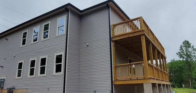 Gray siding building with wooden balconies exterior at Burt, Marcom, Collegeview & Reavis in Raleigh Student Accommodation