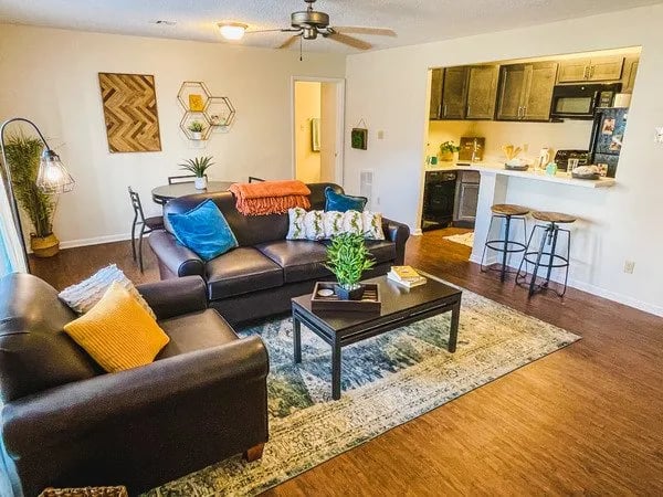 Leather sofas coffee table and kitchen living room at Alight Blacksburg in Blacksburg Student Accommodation