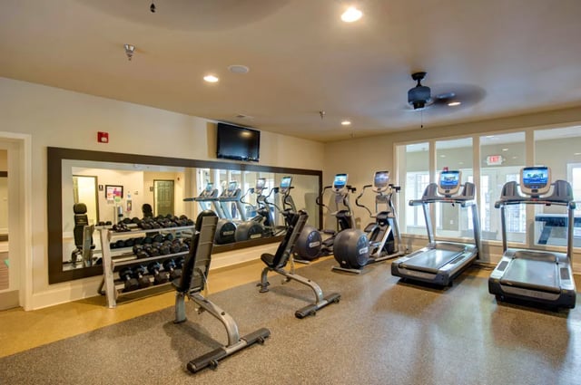 Dumbbell rack treadmills elliptical machines gym bench gym fitness area at The Verge at Asheville in Asheville Student Accommodation
