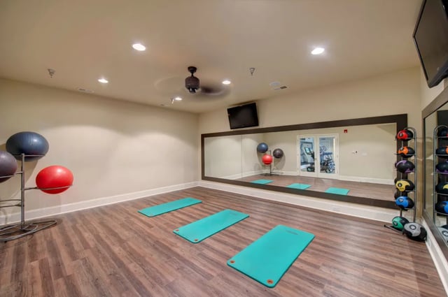 Yoga mats exercise balls large mirror gym interior at The Verge at Asheville in Asheville Student Accommodation
