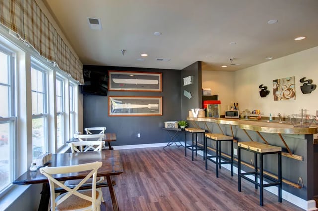 Tables chairs bar counter popcorn machine communal area at The Verge at Asheville in Asheville Student Accommodation