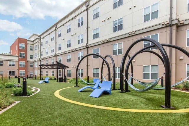 Hammocks lounge chairs and building exterior exterior at Landmark Apartment in College Park Student Accommodation