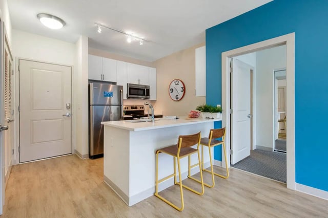 Kitchen with stainless steel appliances and bar stools kitchen at Landmark Apartment in College Park Student Accommodation