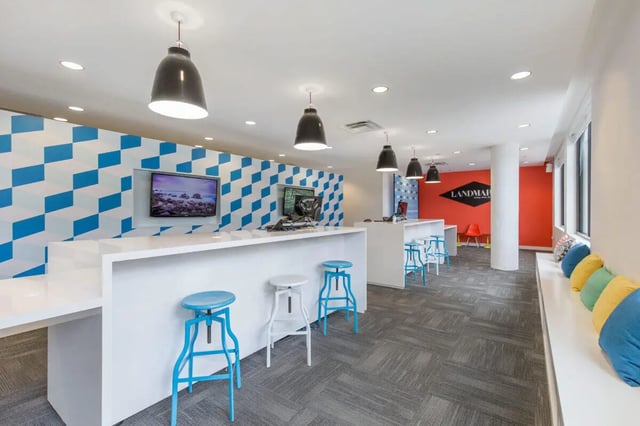 Counter with stools and TV lounge area at Landmark Apartment in College Park Student Accommodation