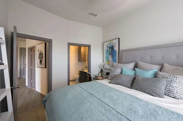 Bed with decorative pillows and abstract art bedroom at Ion at the Ballpark in Birmingham Student Accommodation