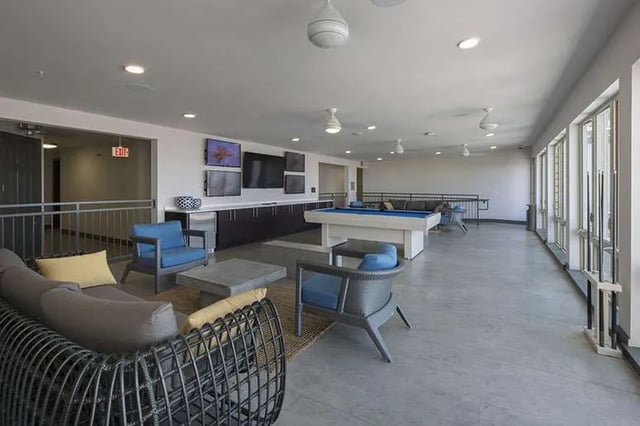 Seating pool table televisions and cabinets common area at Ion at the Ballpark in Birmingham Student Accommodation