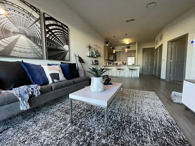 Sofa coffee table rug kitchen area living room at Ion at the Ballpark in Birmingham Student Accommodation