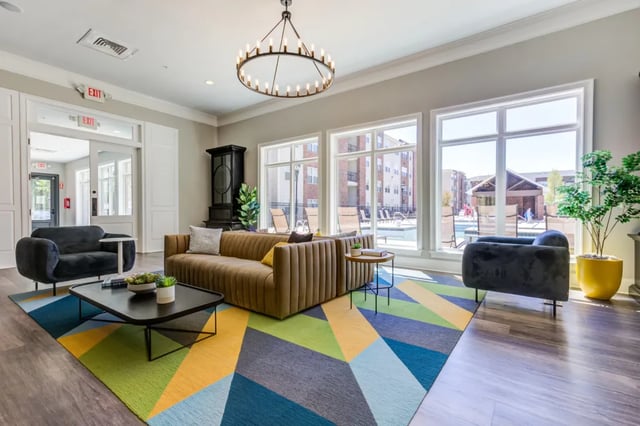 Tan couch with black coffee table geometric rug living room at The Reserve at Greensboro in Greensboro Student Accommodation