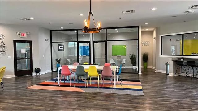 Dining area with colorful chairs and table common area at Copper Beech Townhomes - San Marcos in San Marcos Student Accommodation