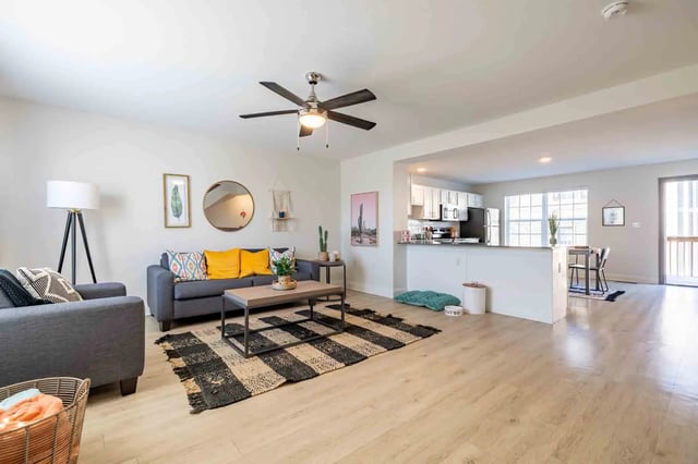Sofa coffee table rug and kitchen living room at Copper Beech Townhomes - San Marcos in San Marcos Student Accommodation