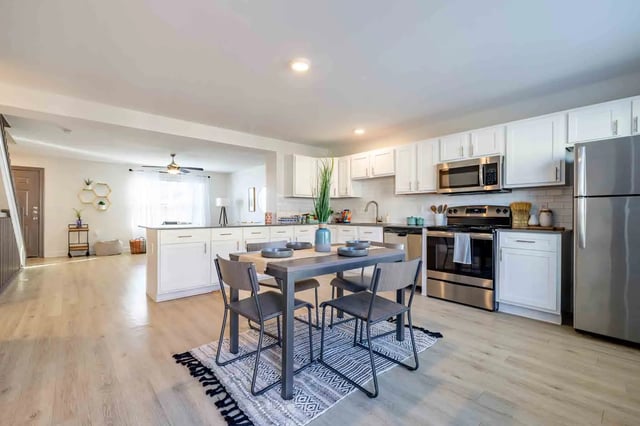 Dining table chairs kitchen with stainless steel appliances kitchen at Copper Beech Townhomes - San Marcos in San Marcos Student Accommodation