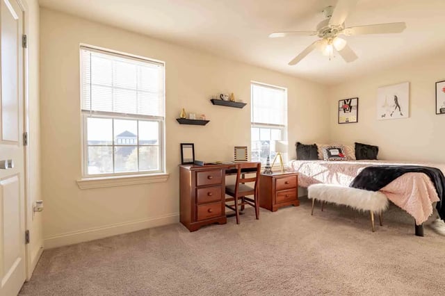 Desk bed and white bench bedroom at Copper Beech Townhomes - San Marcos in San Marcos Student Accommodation