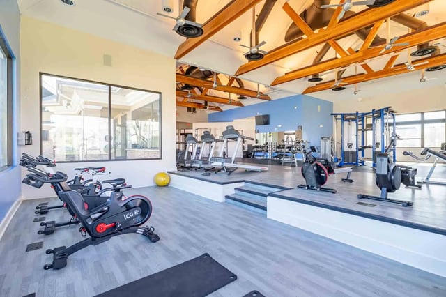 Treadmills exercise bikes rowing machines gym equipment fitness area at Copper Beech Townhomes - San Marcos in San Marcos Student Accommodation