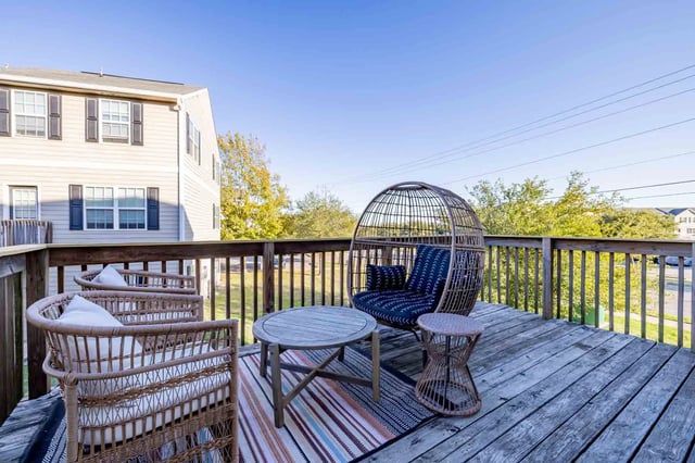 Wicker chairs egg chair table deck exterior at Copper Beech Townhomes - San Marcos in San Marcos Student Accommodation