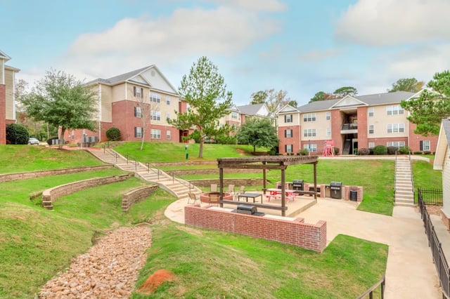 Apartment buildings outdoor patio grills and seating exterior at Grove at Huntsville in Huntsville Student Accommodation