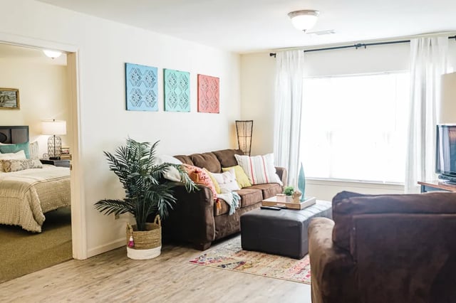 Brown sofa colorful pillows opening to bedroom living room at The Arch at Denton in Denton Student Accommodation