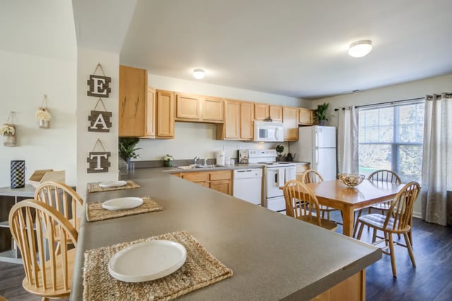 Kitchen island bar counter table and chairs kitchen at Copper Beech Townhomes - Greenville in Greenville Student Accommodation