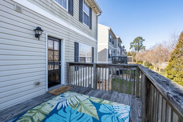 Deck with welcome mat and rug exterior at Copper Beech Townhomes - Greenville in Greenville Student Accommodation