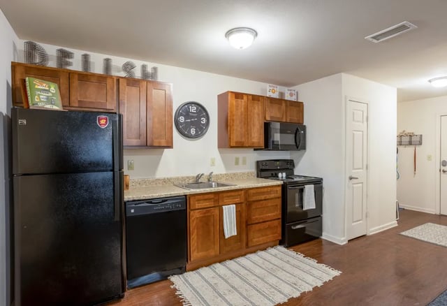 Black refrigerator dishwasher stove microwave kitchen cabinets kitchen at The Reserve Mount Pleasant in Mount Pleasant Student Accommodation