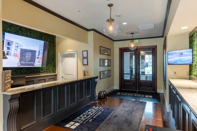 Reception desk with television and double doors Lobby at The Reserve Mount Pleasant in Mount Pleasant Student Accommodation