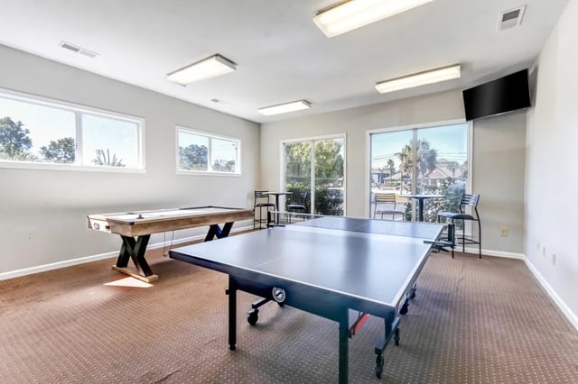 Billiard and ping pong tables with chairs recreation area at Cambridge @ Southern - The Palms in Statesboro Student Accommodation